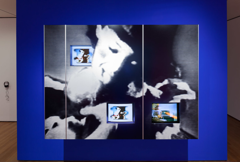 Dara Birnbaum. PM Magazine (detail). 1982. Four-channel video (color, three channels of stereo sound, 6:30 min.), two chromogenic prints, Speed Rail® structural support system, aluminum trim, one wall painted Chroma Key Blue, and one wall painted red, dimensions variable. Installation view, Cut to Swipe, The Museum of Modern Art, New York, October 11, 2014–March 22, 2015. The Museum of Modern Art, New York. Acquired with support from The Modern Women's Fund Committee, The Contemporary Arts Council of The Museum of Modern Art, and through the generosity of Ahmet Kocabiyik, 2014. © 2015 Dara Birnbaum. Image courtesy the artist and Marian Goodman Gallery, New York and Paris