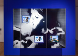 Dara Birnbaum. PM Magazine (detail). 1982. Four-channel video (color, three channels of stereo sound, 6:30 min.), two chromogenic prints, Speed Rail® structural support system, aluminum trim, one wall painted Chroma Key Blue, and one wall painted red, dimensions variable. Installation view, Cut to Swipe, The Museum of Modern Art, New York, October 11, 2014–March 22, 2015. The Museum of Modern Art, New York. Acquired with support from The Modern Women's Fund Committee, The Contemporary Arts Council of The Museum of Modern Art, and through the generosity of Ahmet Kocabiyik, 2014. © 2015 Dara Birnbaum. Image courtesy the artist and Marian Goodman Gallery, New York and Paris