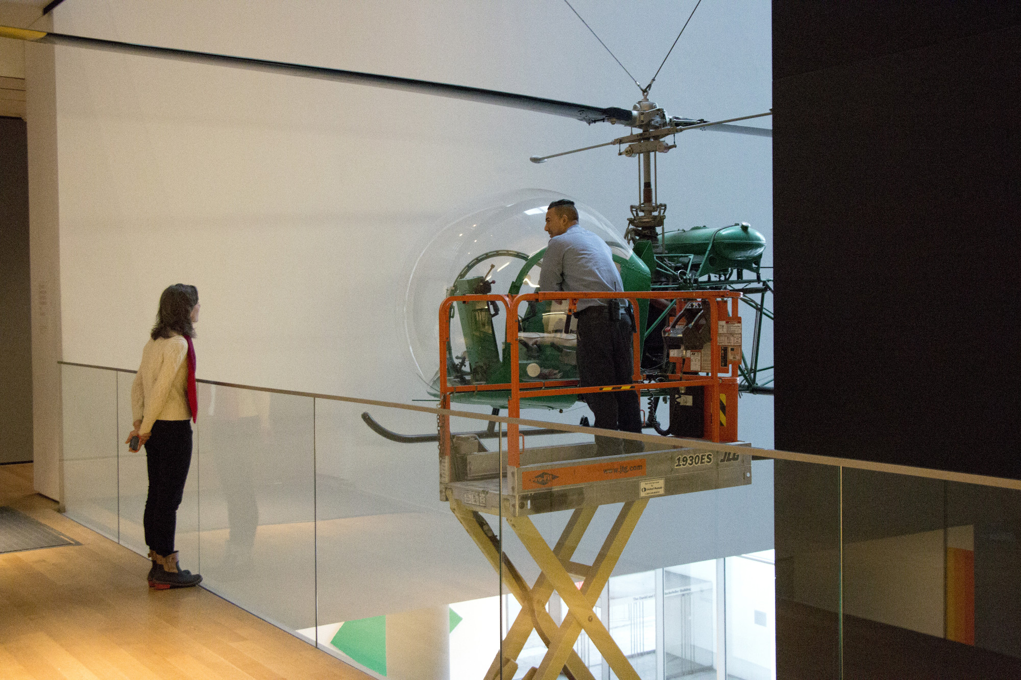 Artist Nina Katchadourian watches the dusting of the helicopter. Shown: Arthur Young. Bell-47D1 Helicopter. 1945. Aluminum, steel, and acrylic plastic. Manufactured by Bell Helicopter Inc., Buffalo, NY. Marshall Cogan Purchase Fund. Photo: Manuel Martagon. © 2016 The Museum of Modern Art