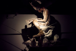 Pope.L (American, born 1955). Eating the Wall Street Journal, Version 3, SculptureCenter, New York. 2000. Inkjet print, 10 × 15" (25.4 × 38.1 cm). The Museum of Modern Art, New York. Acquired in part through the generosity of Jill and Peter Kraus, Anne and Joel S. Ehrenkranz, The Contemporary Arts Council of The Museum of Modern Art, The Jill and Peter Kraus Media and Performance Acquisition Fund, and Jill and Peter Kraus in honor of Michael Lynne. © Pope.L, courtesy the artist