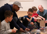 Image of the family program "Explore This! Activity Stations”. 2019. Digital Image © The Museum of Modern Art, New York. New York Photo: Manuel Martagon Image description: Participants engaged in an activity during a Family Gallery Talk.