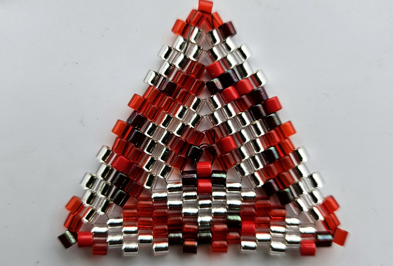 Photo: Beaded triangle. Image courtesy the artist