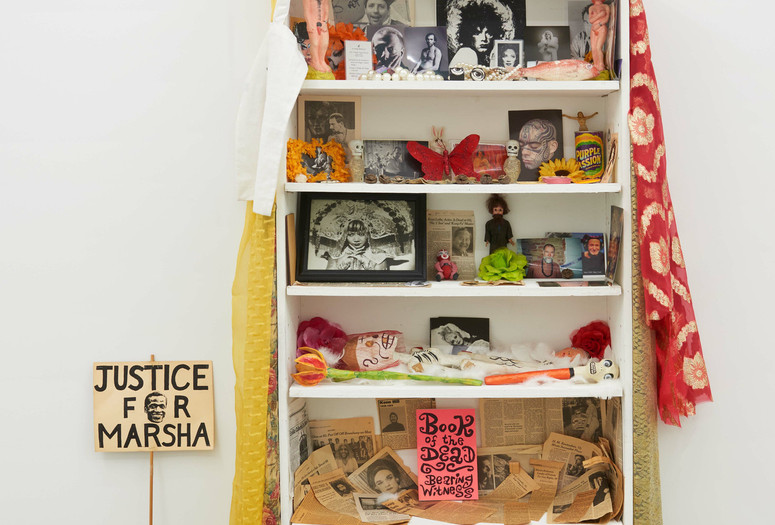Agosto Machado. Shrine (White). 2022. Mixed-media installation, with jewelry, pins, and textiles; plastic, metal, glass, and papier-mâché objects; photographs, postcards, paper mask, protest sign, memorial-service cards and programs and newspaper and magazine clippings; and original artworks by Scott Covert, Ken Angel Davis with CAConrad, and Gene Fedorko with Stephen Tashjian (Tabboo!), 91 1/2 × 36 × 10" (232.4 × 91.4 × 25.4 cm). The Museum of Modern Art, New York. Acquired through the generosity of Scott Lorinsky. © 2024 Agosto Machado. Courtesy of the artist