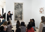 An educator leads a conversation about an artwork during a Family Gallery Talk. Photo: Martin Seck