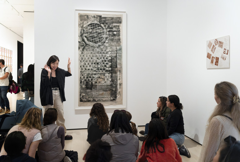 An educator leads a conversation about an artwork during a Family Gallery Talk. Photo: Martin Seck