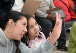 Photo: Martin SeckImage description: A caregiver explains something to the child beside them.