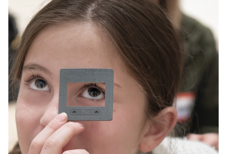 Photo: Martin SeckImage description: A child looks up through a viewfinder