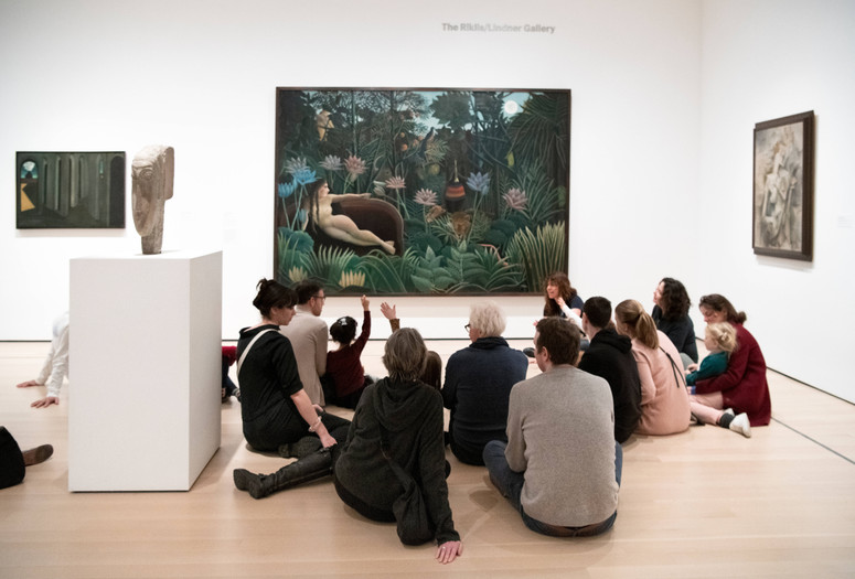 Photo: Martin SeckImage description: An educator leads a group of families in a discussion about an artwork.