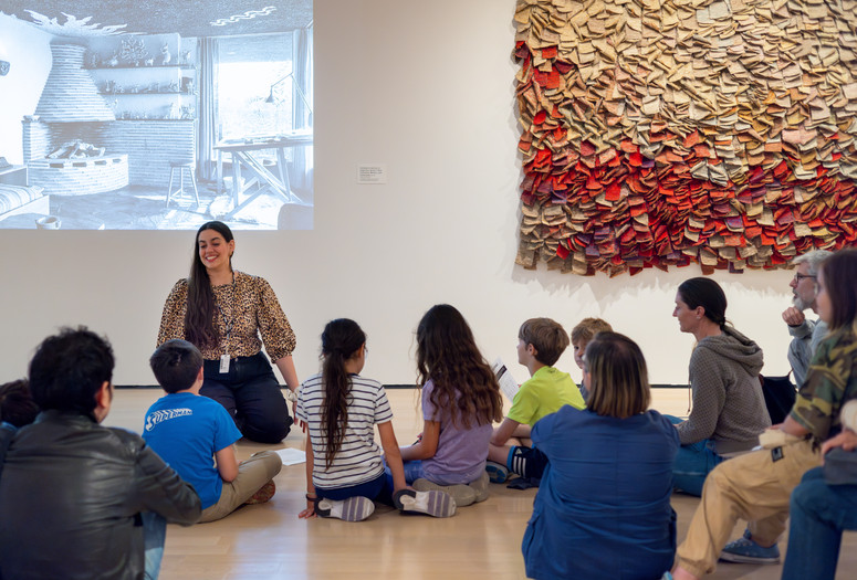 Photo: On White Wall Inc.Image description: An educator leads a discussion about an artwork for seated families.
