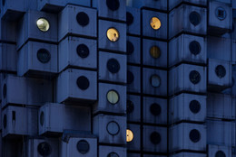 Night time at the Nakagin Capsule Tower, with Mr. Takayuki Sekine seen through the window of capsule B1004, 2016. © Jeremie Souteyrat