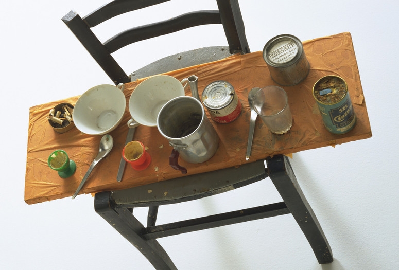 Daniel Spoerri. Kichka's Breakfast I. 1960. Wood chair hung on wall with board across seat, coffeepot, tumbler, china, eggcups, eggshells, cigarette butts, spoons, tin cans, and other materials. The Museum of Modern Art, New York. Philip Johnson Fund. © 2025 Daniel Spoerri/Artists Rights Society (ARS), New York/ProLitteris, Switzerland