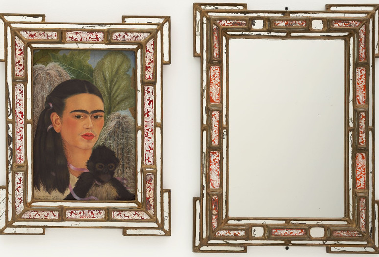 Frida Kahlo. Fulang-Chang and I. 1937 (assembled after 1939). In two parts, oil on board (1937) with painted mirror frame (added after 1939); and mirror with painted mirror frame (after 1939). The Museum of Modern Art, New York. Mary Sklar Bequest. © 2025 Banco de México Diego Rivera Frida Kahlo Museums Trust, Mexico, D.F./Artists Rights Society (ARS), New York Image description: A diptych featuring a mirror next to an oil painting of a dark-haired female figure with a unibrow, a self-portrait, with a small dark brown monkey sitting on her chest. A pink ribbon winds from the monkey to the female figure’s neck and hair. Both pieces have matching bronze frames with red painted inlay and mirrored edges.
