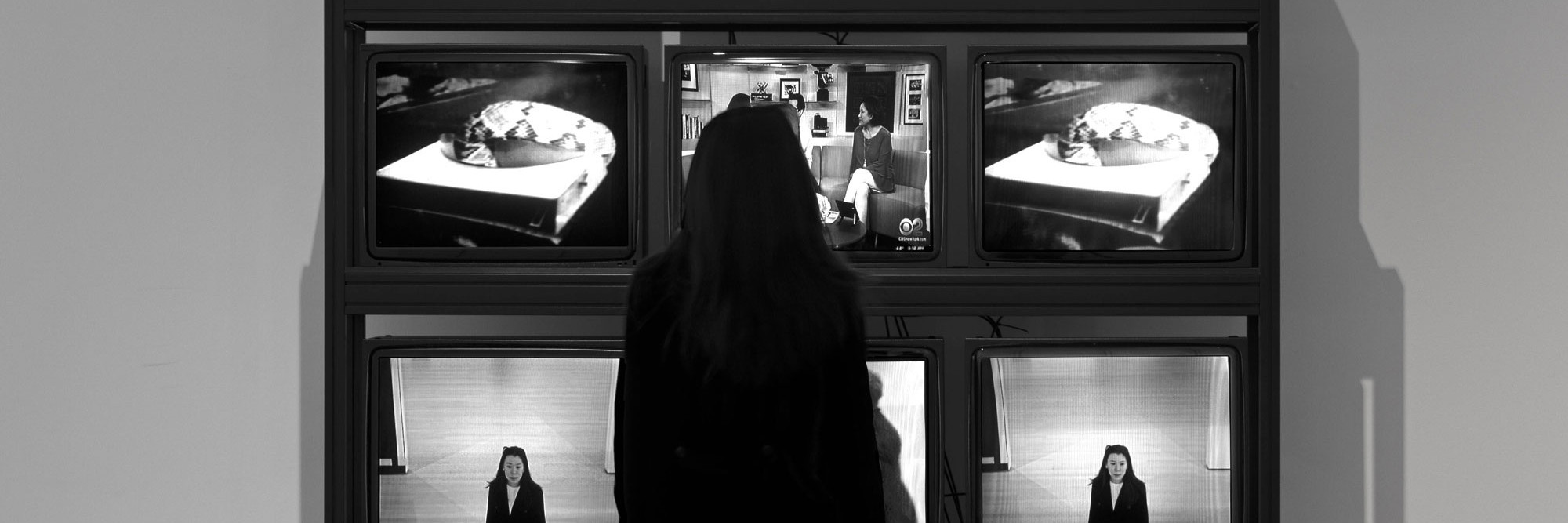 Installation view of the exhibition Signals: How Video Transformed the World, The Museum of Modern Art, New York, March 5–July 8, 2023. Photo: Robert Gerhardt. Digital image © 2026 The Museum of Modern Art, New York. Shown: Frank Gillette, Ira Schneider. Wipe Cycle. 1969/2017. Two standard-definition videos (black and white, silent; 30 min.); sound; live television broadcast; surveillance camera; nine cathode-ray tube monitors; custom-made video switcher, micro-controllers, and software; shelving, 94 1/2 × 82 11/16 × 29 9/16" (240 × 210 × 75 cm). The Museum of Modern Art, New York. Acquired through the generosity of Maja Oeri. © 2026 Frank Gillette and Ira Schneider Artworks Company LLC