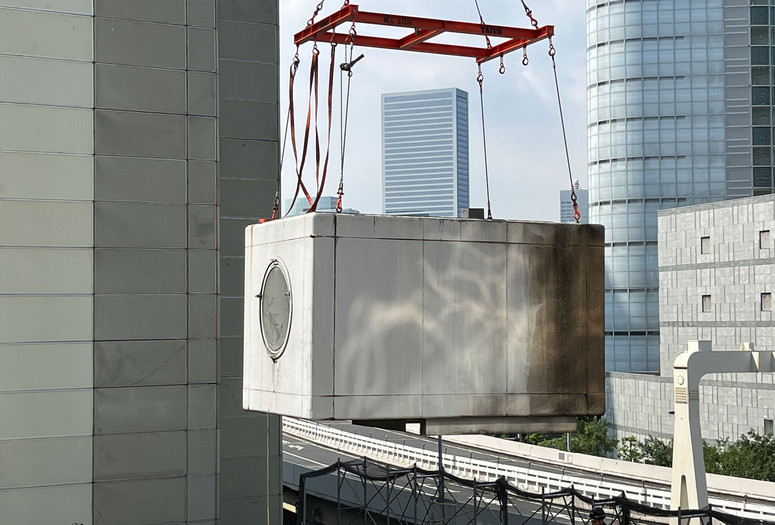 A capsule from the Nakagin Capsule Tower in midair during the building’s dismantling, 2022. Photo: The Nakagin Capsule Tower Restoration and Preservation Project