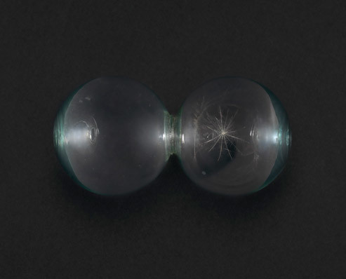 Nicolás Paris (b. 1977, Bogotá). Detours. 2016. Handblown double-headed glass bulb containing a seed, 4 × 7 1/2 × 4″ (10 × 19 × 10 cm)