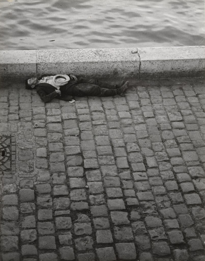 Brassaï (Gyula Halász). Man Sleeping Along the Seine. (Homme endormi au bord de la Seine). 1932