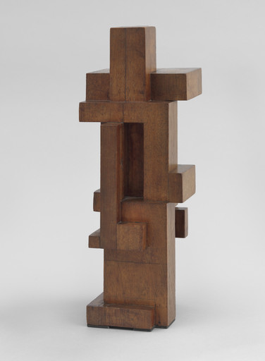 Wooden sculpture with interlocking rectangular shapes, predominantly brown. The piece stands on a flat base against a light gray background. This is an AI generated description. To give feedback, email ai@moma.org.