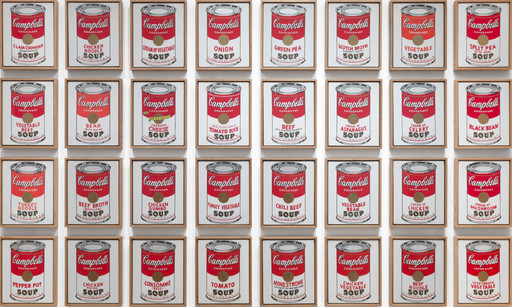 Framed images of soup cans arranged in a grid pattern, featuring bold reds and whites. The medium appears to be printed artwork. This is an AI generated description. To give feedback, email ai@moma.org.