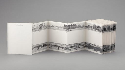 An accordion-style book is open to show black-and-white panoramic images of city streets and buildings. The cover, which reads "The Sunset Strip," and the pages are primarily white with gray accents. This is an AI generated description. To give feedback, email ai@moma.org.